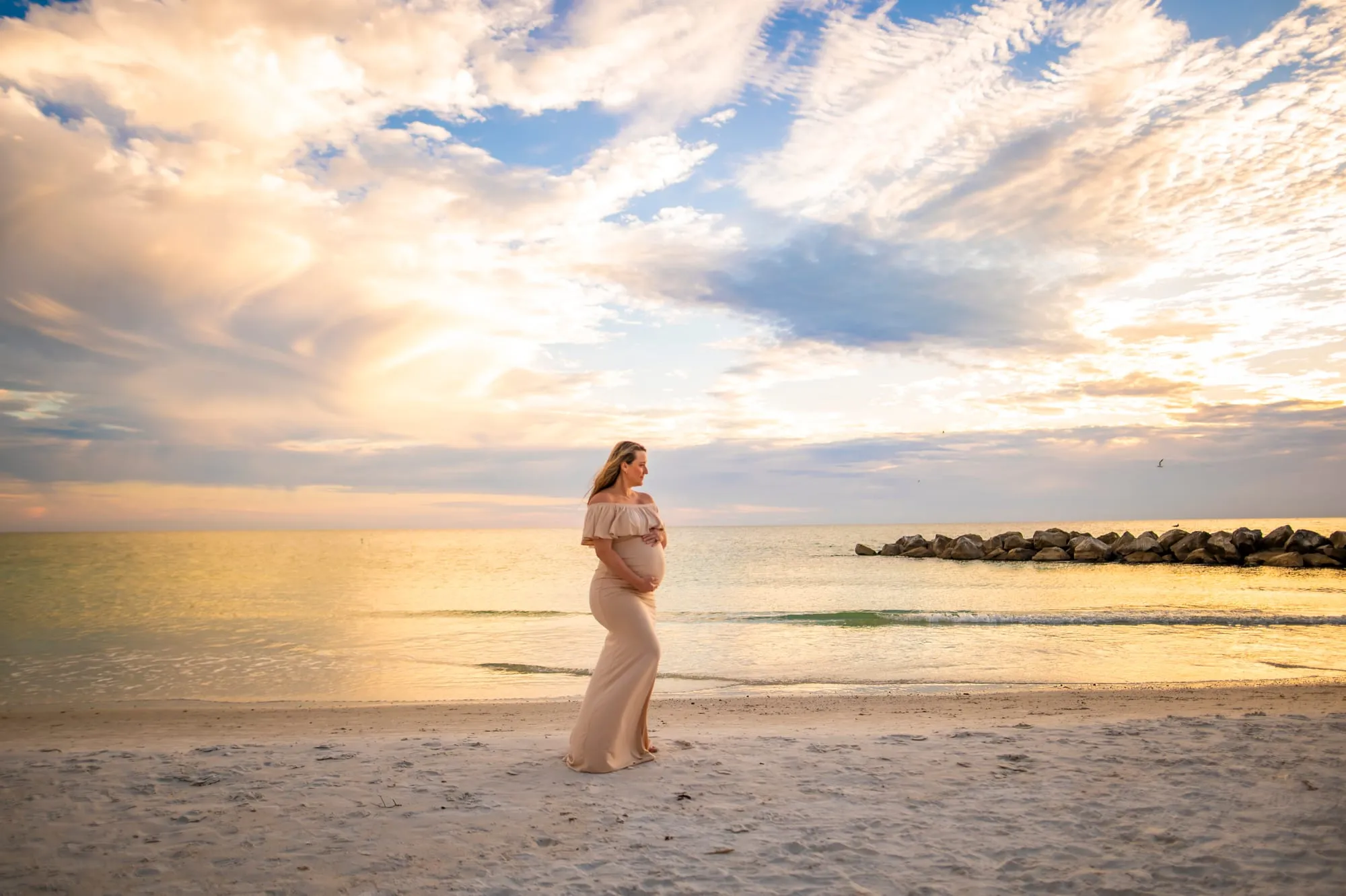Brittaney Bialas maternity photo at sunset on Florida beach, LifeBloom Nutrition founder
